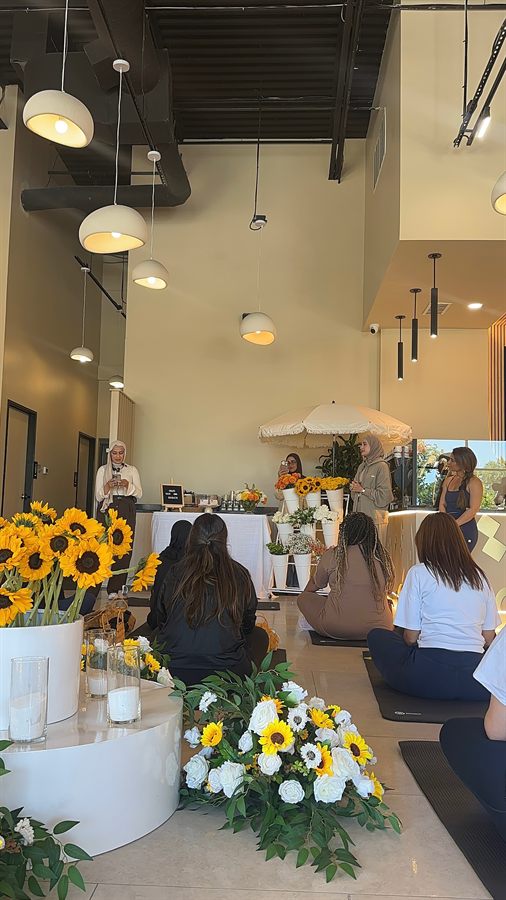Women connecting at an EmpowerHer Voices wellness event